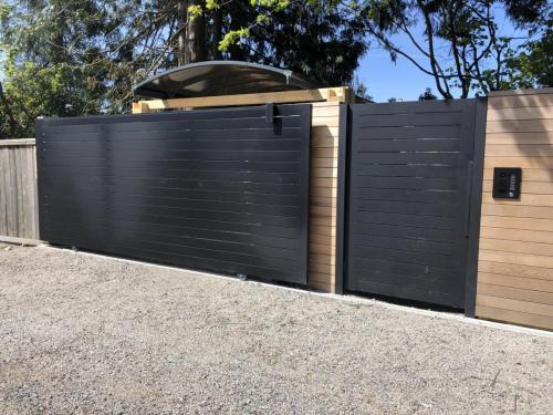 TG988 Resident sliding gate with man gate horizontal aluminum tubes in Vancouver